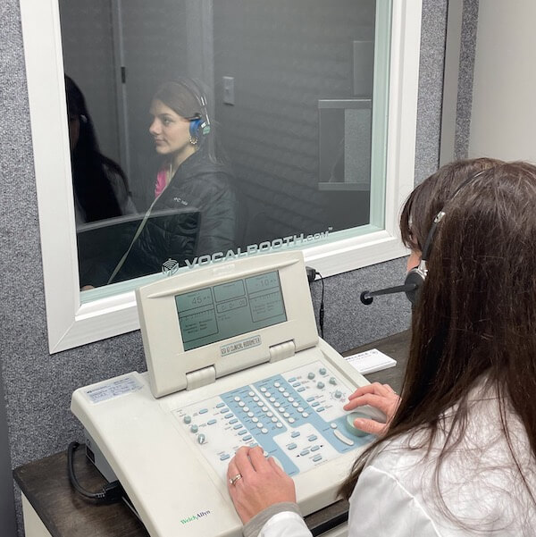 patient in a sound box for hearing test